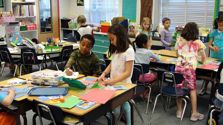 Students work together on arts and crafts in an elementary school classroom