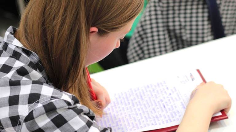 A student looks over their written work