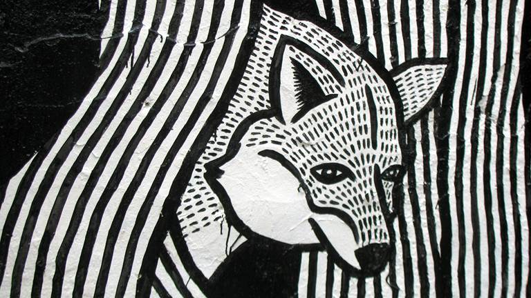 A black and white painting of a fox. 