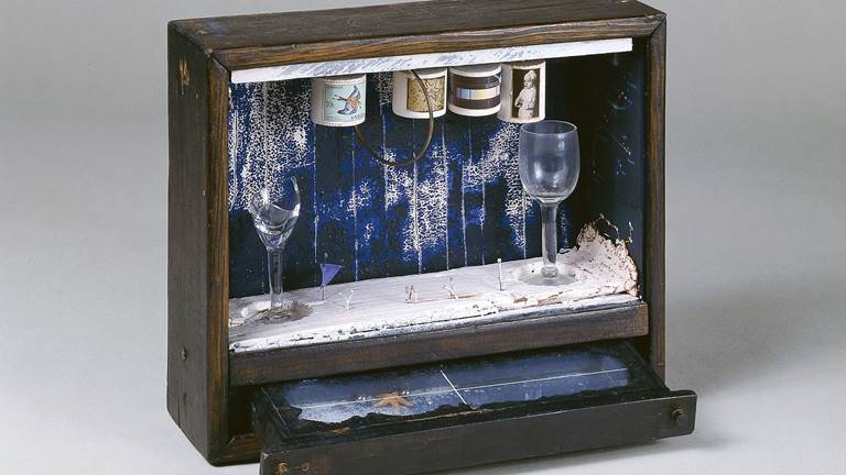 An identity by Joseph Cornell titled, Blue Soap Bubble. The objects in the box are symbols of the artists' childhood memories. For example, the blue-painted drawer represents the sea. The four cylinders represent his four family members