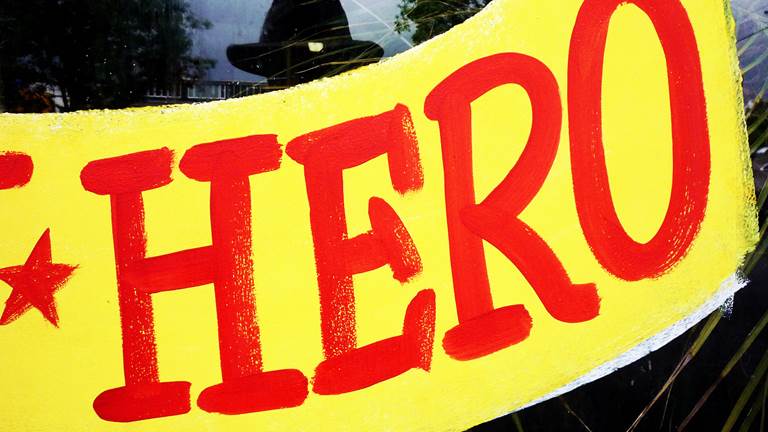 The word "Hero" painted in red on a window. 