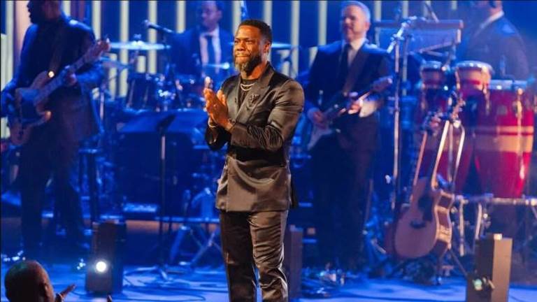 Kevin Hart claps toward the audience from the stage of the Mark Twain Prize at the Kennedy Center